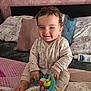 Elena a rejoint le concours — aidez-le/la à gagner de superbes lots ! baby, bed, blanket, child, comfort, cute, face, foot, hand, head, indoor, infant, lotion, pajamas, person, pillow, play, sitting, smiling, toy