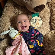 Florence joined the competition — help win amazing prizes! baby, smile, teddy_bear, stuffed_animal, blanket, bunny, infant, clothing, floral_pattern, face, happy, child, portrait, cute, soft_toy, milestone, indoor, baby_girl, cuddly, comfort