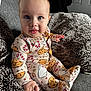 baby, child, pajamas, cookies, candy_canes, blanket, cozy, indoor, cute, blue_eyes, drool, hand, footed_pajamas, seated, smiling, face, infant, soft_fabric, home, portrait