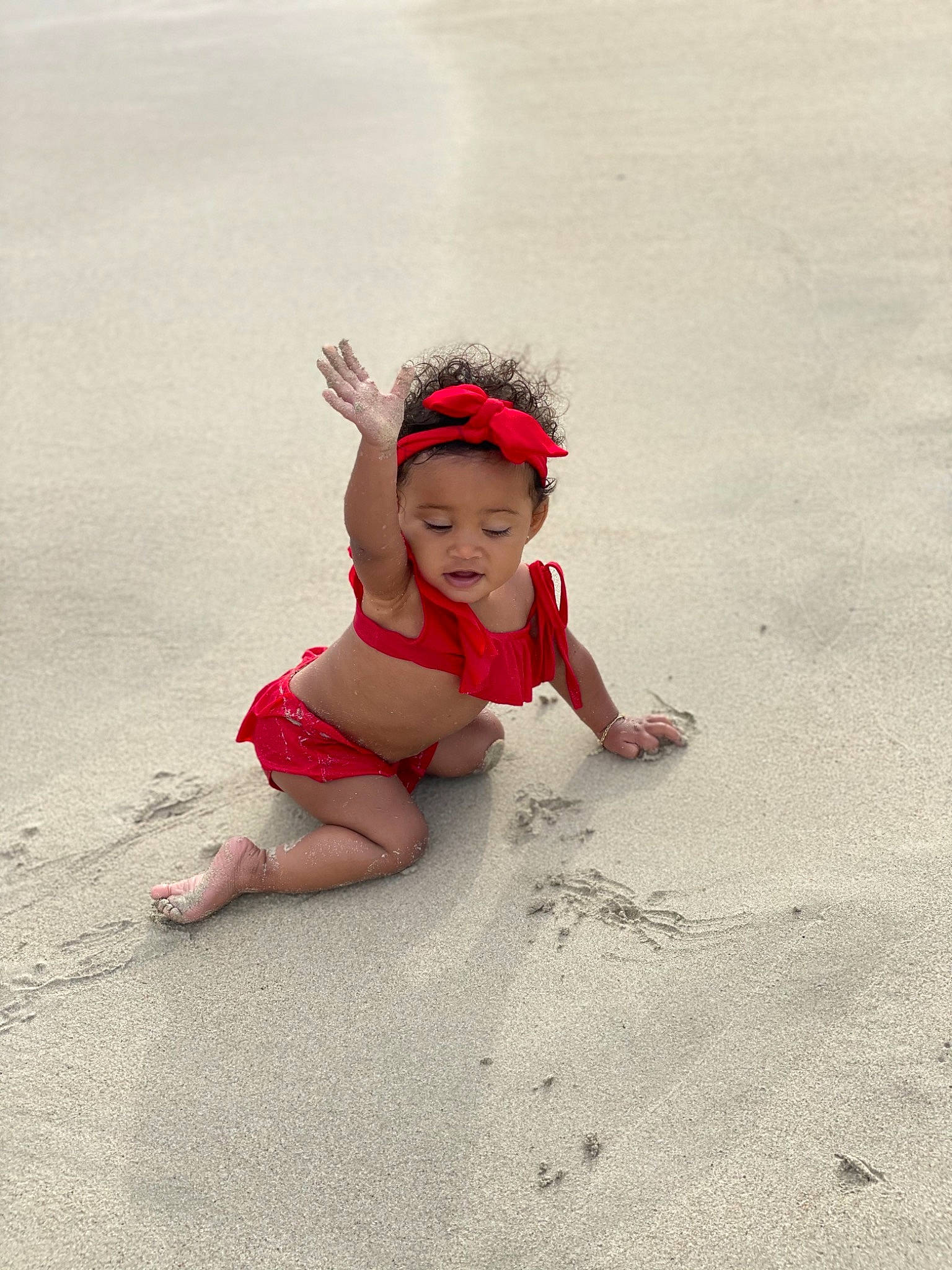 Summer is registered to the contest to win money with this photo: asphalt, baby, barefoot, beach, child, flooring, foot, fun, happy, head, headwear, human_leg, landscape, leg, leisure, person, recreation, sand, sitting, soil