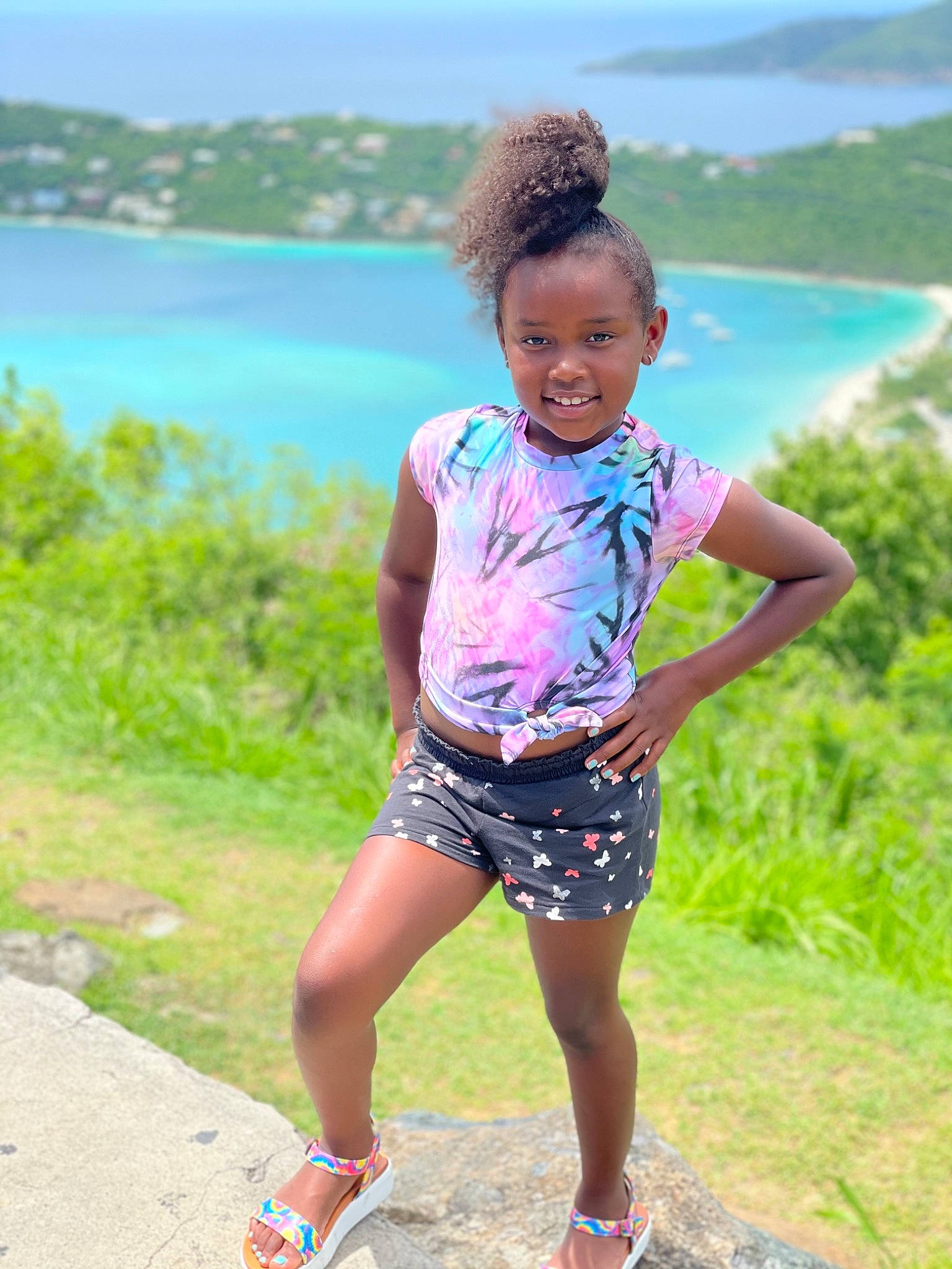 Aziyah is registered to the contest to win money with this photo: electric_blue, facial_expression, fun, grass, green, happy, human_leg, joy, lake, landscape, leisure, people_in_nature, person, plant, recreation, sand, shore, shorts, sky, smile