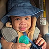baby, blanket, blue_hat, car_seat, child, clothing, cute, eyes, face, hand, headwear, indoors, infant, pacifier, person, portrait, seatbelt, skin, smile, young_child