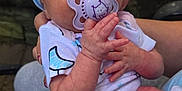 Raelynne is registered to the contest to win money with this photo: baby, infant, pacifier, headband, blue, hands, outdoor, nature, sleeping, clothing, person, cute, newborn, holding, skin, face, peaceful, small, child, toddler