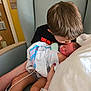 Raelynne joined the competition — help win amazing prizes! child, newborn, baby, hospital, blanket, love, family, tenderness, affection, chair, person, medical, comfort, holding, young_child, indoor, parent, healthcare, caring, rest