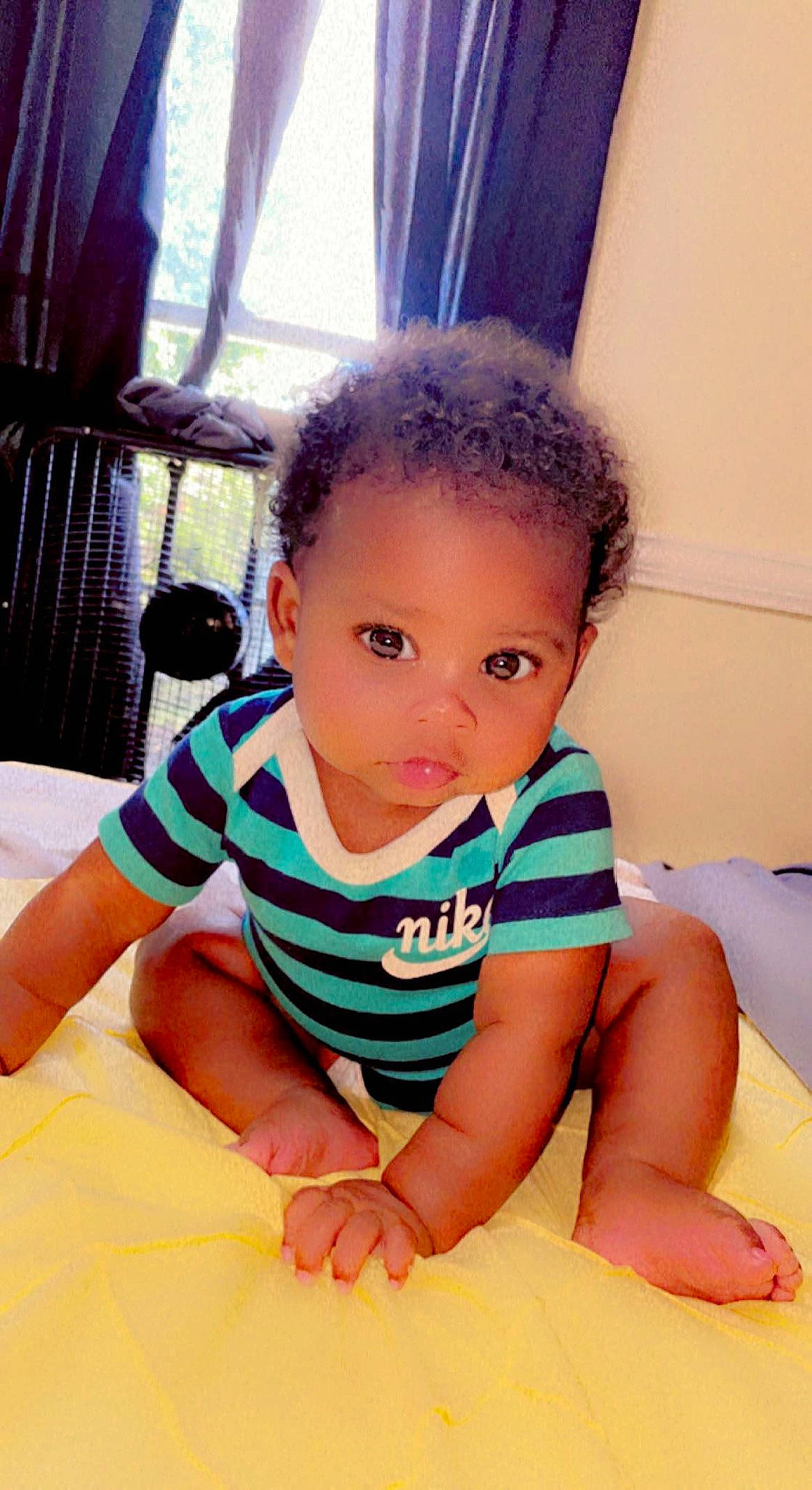 Liberty is registered to the contest to win money with this photo: baby, baby_toddler_clothing, cheek, comfort, curtain, elbow, finger, floor, flooring, happy, iris, leisure, mouth, neck, nose, person, sitting, skin, sleeve, t_shirt