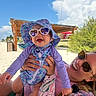 baby, woman, sunglasses, hat, beach, sand, sunny, smile, joyful, outdoor, ocean, vacation, summer, happy, child, parent, sunhat, colorful_clothing, nature, relaxation