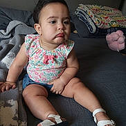 Ocean joined the competition — help win amazing prizes! child, toddler, baby, indoor, bed, blanket, plush_toy, clothing, footwear, pout, sitting, person, cute, expression, home, casual, comfort, soft_lighting, shorts, floral