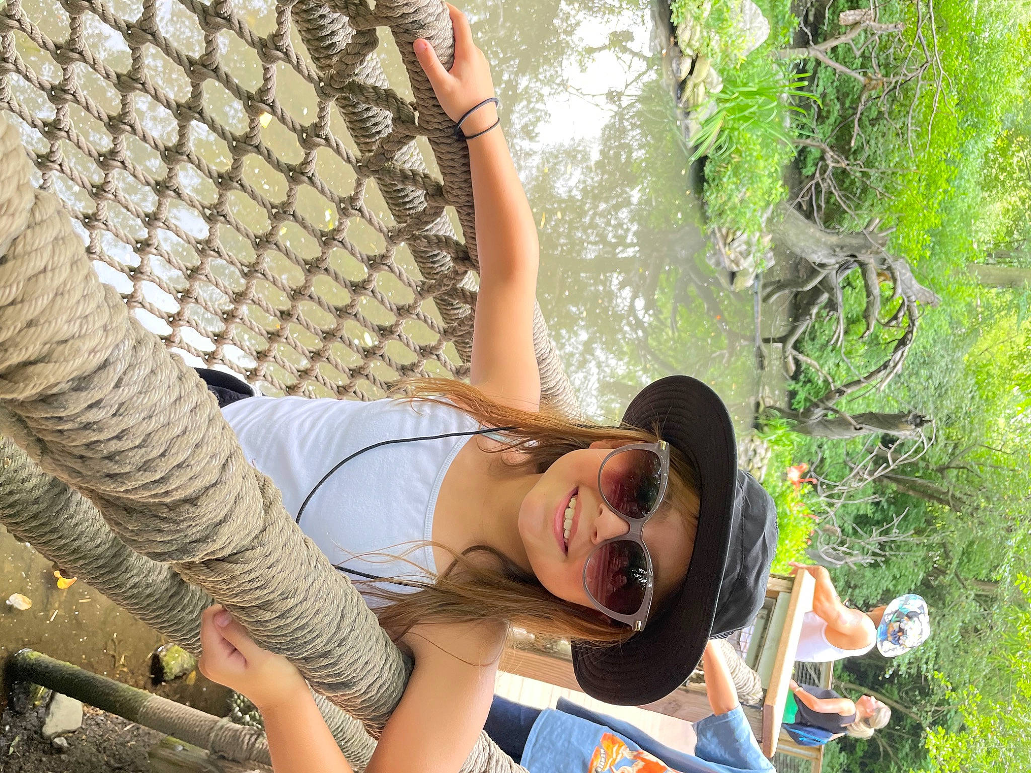 Kenzie joined the competition — help win amazing prizes! eyewear, fun, grass, happy, headwear, joy, jungle, landscape, leisure, mesh, people_in_nature, person, plant, recreation, sandal, smile, summer, sunglasses, t_shirt, thigh