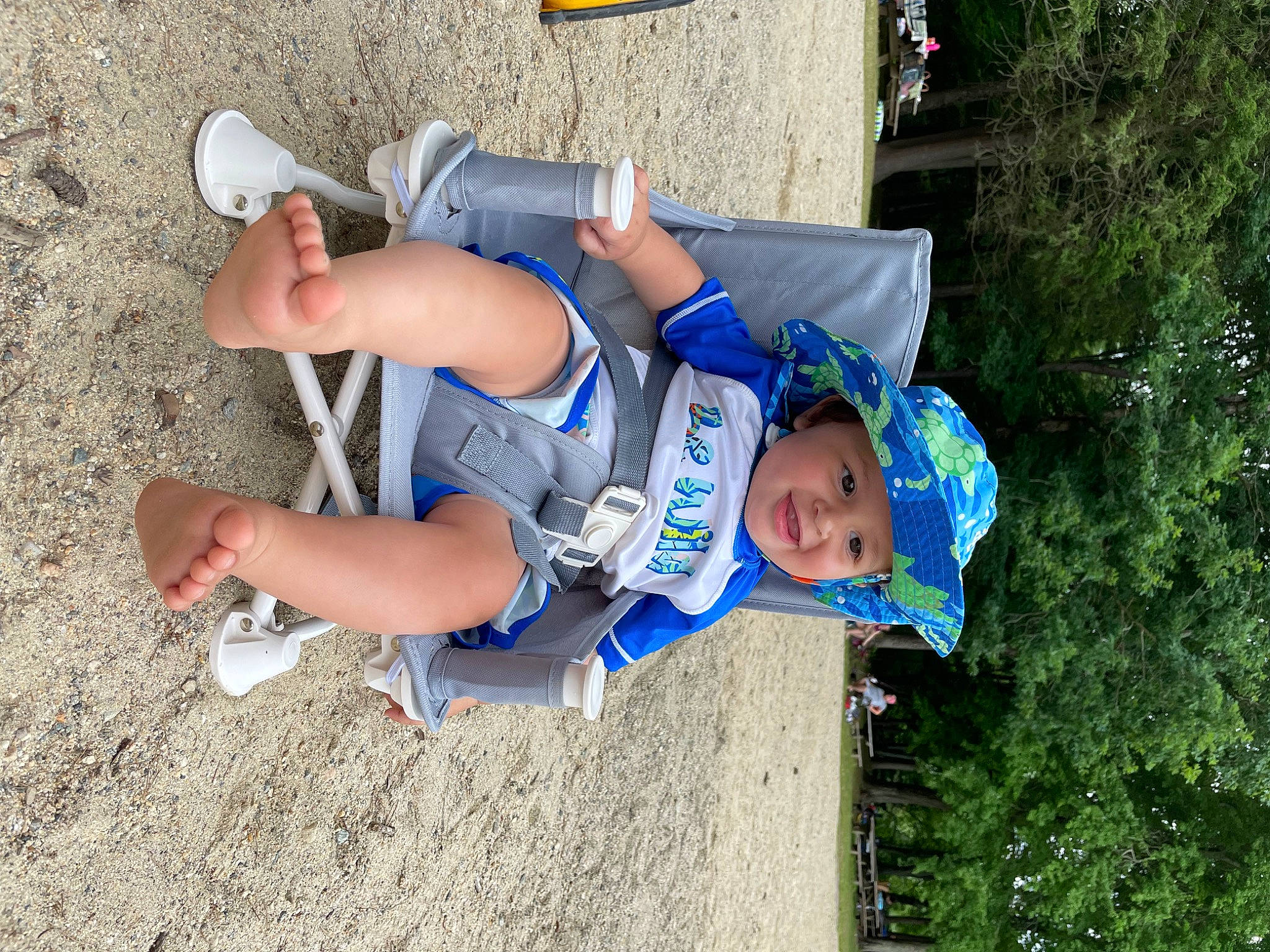 Jabari is registered to the contest to win money with this photo: child, competition_event, electric_blue, foot, fun, grass, hat, headwear, human_leg, knee, leisure, person, plant, recreation, shorts, sneakers, sock, soil, t_shirt, thigh