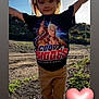 Mila joined the competition — help win amazing prizes! child, girl, pigtails, tshirt, graphic_tshirt, outdoor, sunlight, smile, arms_raised, cody_rhodes, wrestler_image, pants, nature, grass, dirt_path, happy, portrait, casual_clothing, cute, emoji_heart