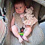 baby, car_seat, plush_toy, pacifier, infant, child, soft_toy, seat_belt, fabric, cute, indoor, comfort, pink, expression, skin, foot, hand, toy, sitting, closeup