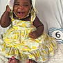 baby, child, smiling, happy, sitting, dress, hat, indoor, blanket, milestone, sign, feet, cute, infant, portrait, person, fabric, pattern, yellow, celebration