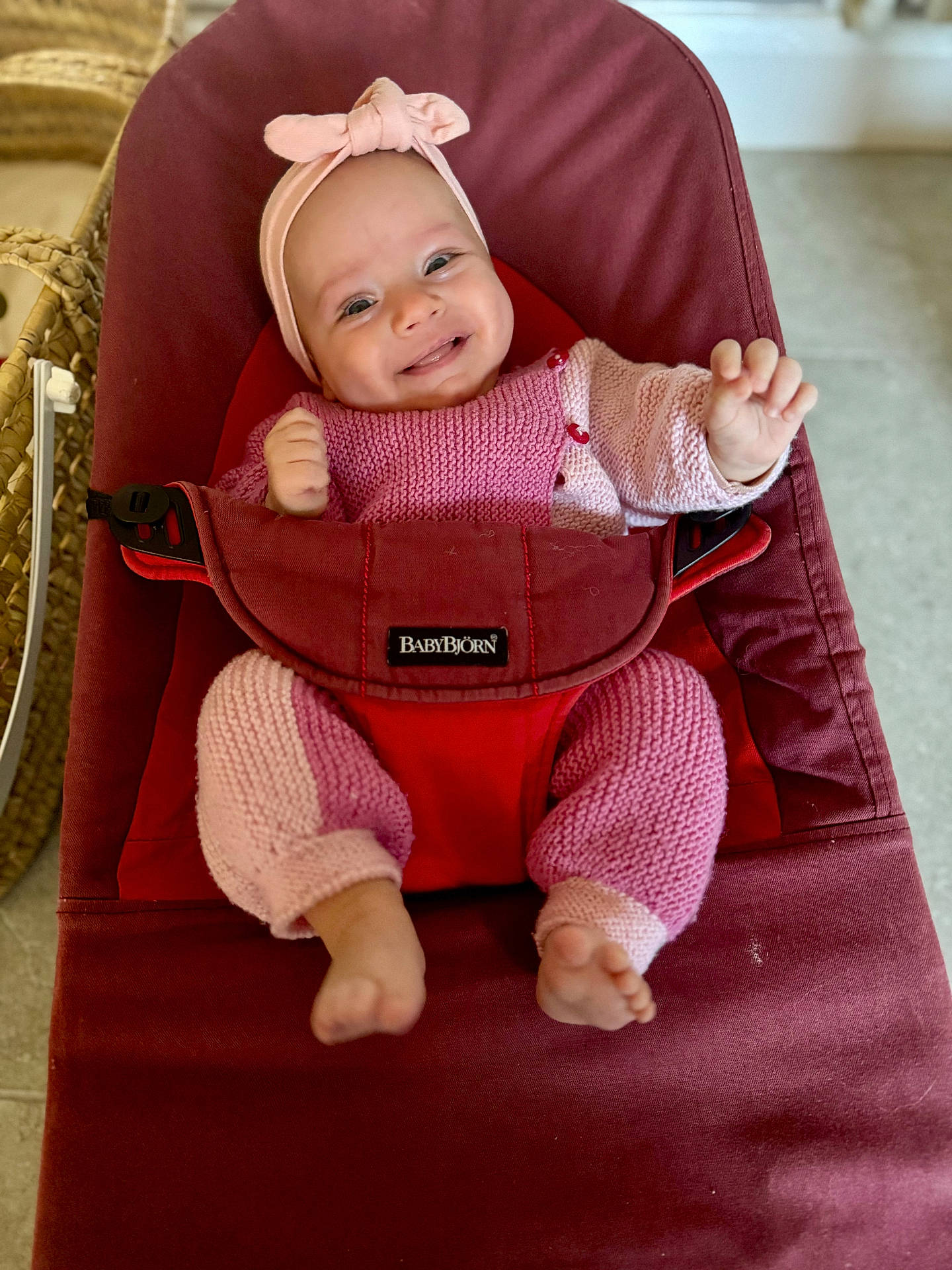 baby, bodypart, bonnet, cap, chair, clothing, couch, face, finger, furniture, hand, happy, hat, head, knitwear, person, photography, portrait, smile, sweater