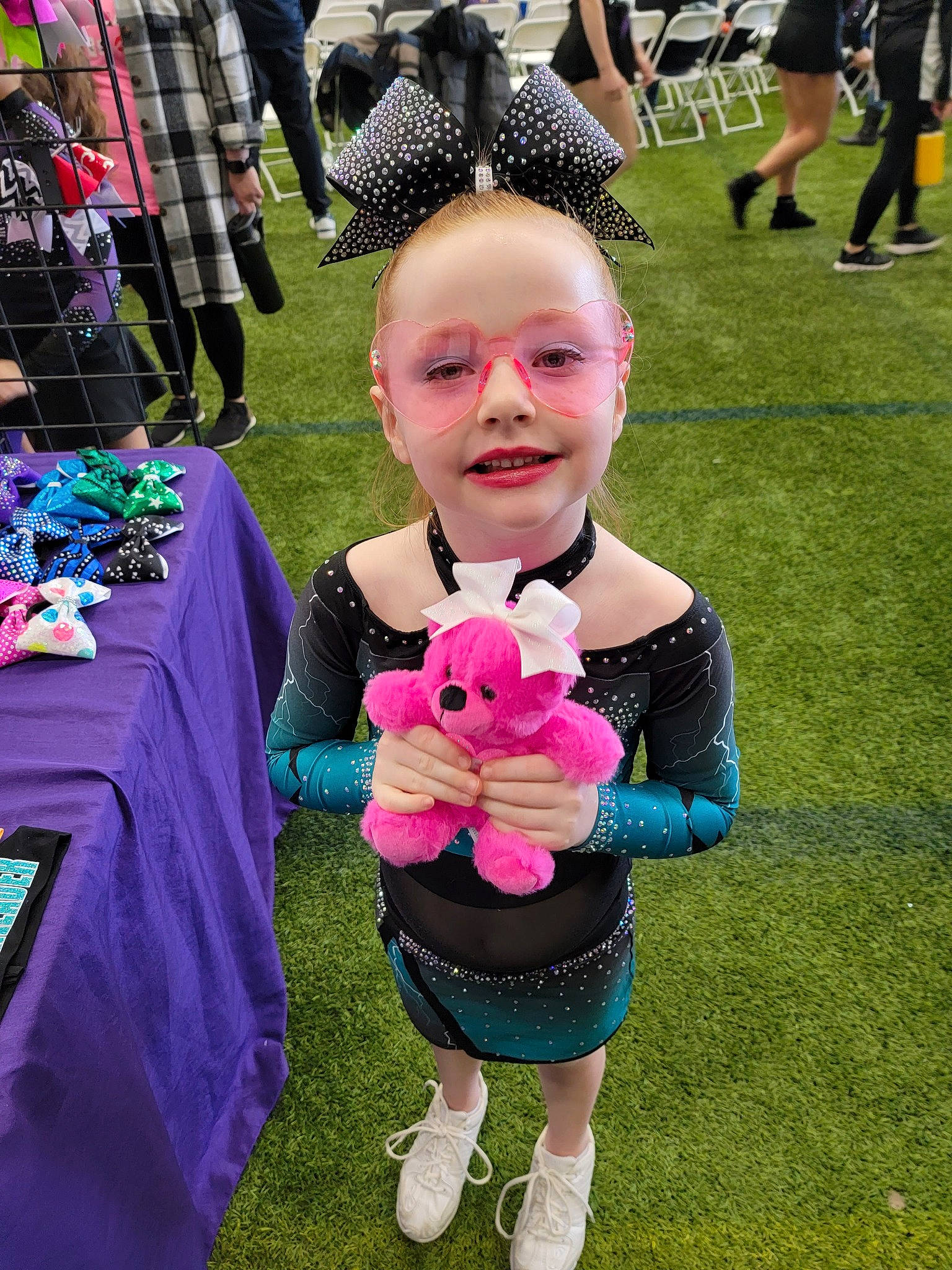 Teegan is registered to the contest to win money with this photo: child, costume, event, fun, fur, games, grass, green, happy, joy, leisure, luggage_and_bags, magenta, mammal, person, pink, recreation, shorts, smile, t_shirt