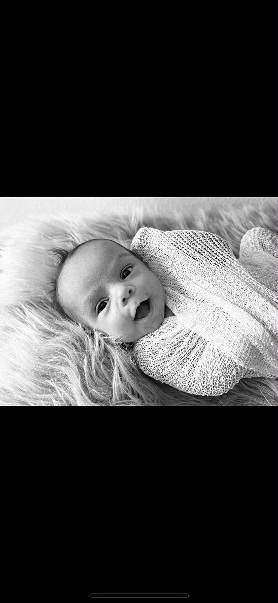 Kaisyn joined the competition — help win amazing prizes! baby, infant, smiling, wrapped, blanket, knitted, black_and_white, portrait, closeup, cute, happy, lying_down, fur_texture, soft, young_child, face, expression, newborn, cozy, warm