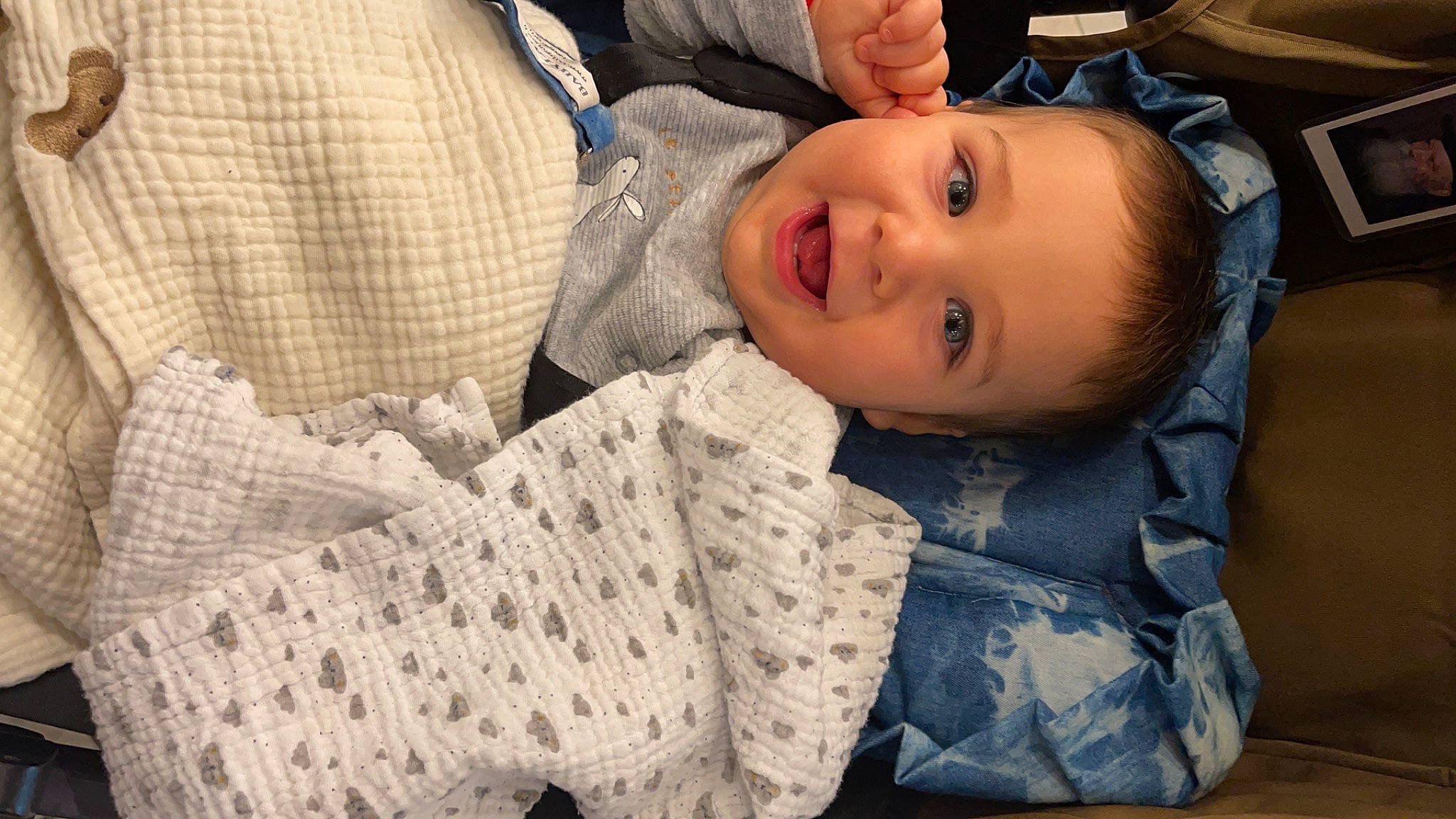 Ilay participe au concours pour gagner de l'argent avec cette photo : baby, baby_toddler_clothing, bedding, child, comfort, flash_photography, grass, happy, hat, linens, pattern, person, plaid, portrait_photography, sitting, skin, sleeve, smile, textile, toddler