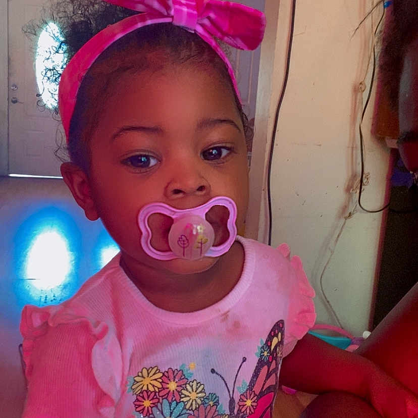 Hazel joined the competition — help win amazing prizes! accessories, baby, bodypart, clothing, couch, face, finger, furniture, glasses, hand, hat, head, headband, indoors, lighting, person, photography, portrait, purple, t_shirt