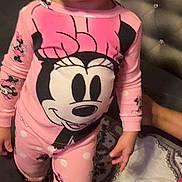 Reya is registered to the contest to win money with this photo: toddler, child, pajamas, pink_clothing, minnie_mouse, bed, blanket, headboard, curious, indoor, person, cute, sleepwear, patterned_blanket, small_child, standing, face, hair, cozy, bedroom