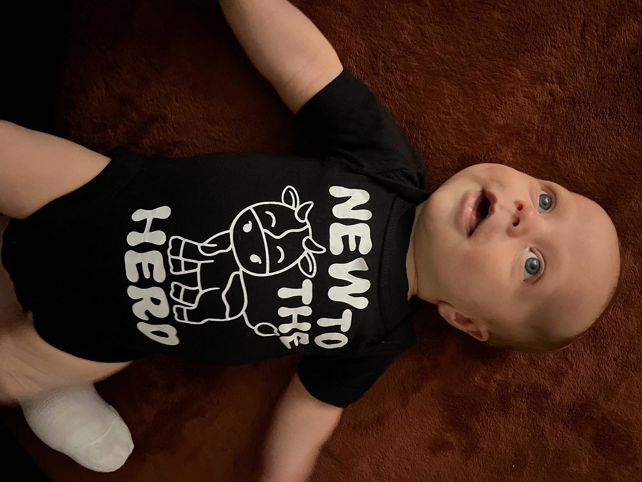 Kevin is registered to the contest to win money with this photo: chest, cool, elbow, eyelash, flash_photography, flesh, flooring, font, gesture, human_leg, pattern, person, sitting, sleeve, t_shirt, thigh, toddler, top, waist, wood