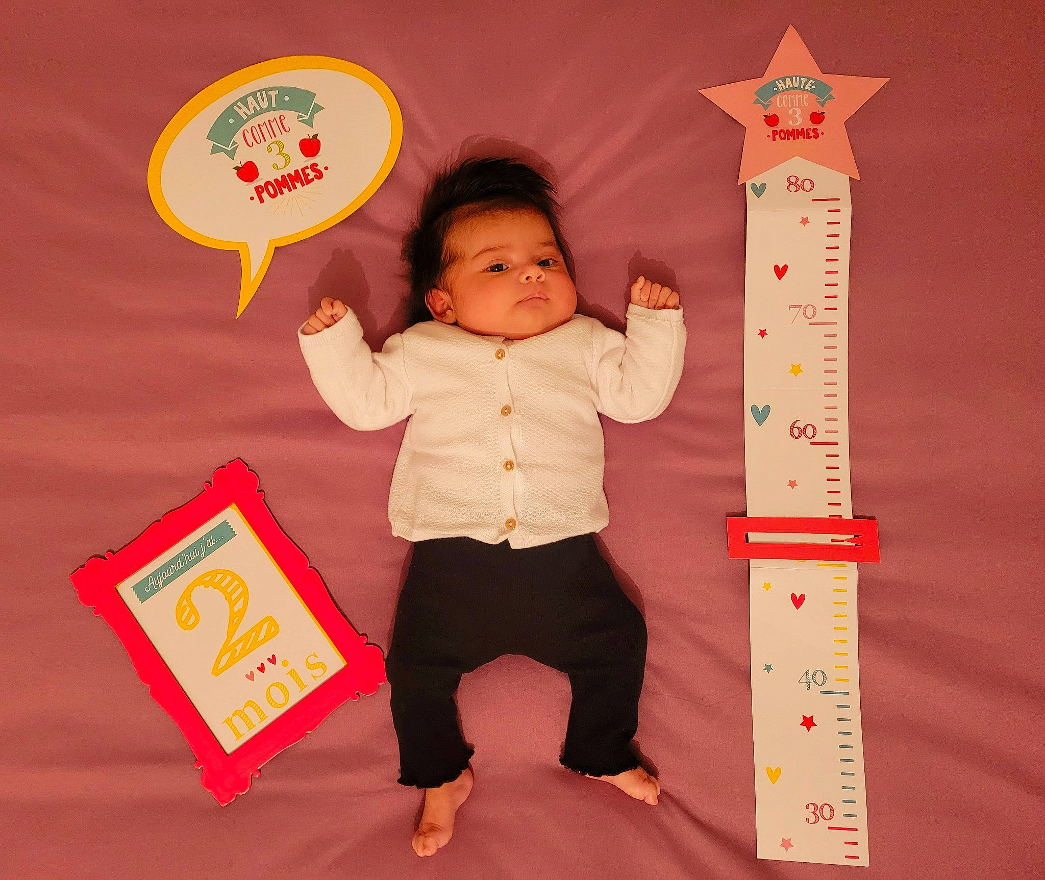 Esmeralda participe au concours pour gagner de l'argent avec cette photo : baby, baby_toddler_clothing, carmine, child, flooring, fun, gesture, happy, magenta, material_property, paper_product, pattern, person, play, product, rectangle, room, sleeve, standing, thumb