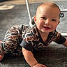 baby, crawling, carpet, indoor, smiling, child, pajamas, camo_pattern, face, young_child, cute, happy, person, floor, head, skin, hand, photography, infant, social_media