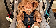 Kayce joined the competition — help win amazing prizes! adorable, baby, bear_ears, car_seat, child, couch, cute, fuzzy_clothing, indoor, infant, newborn, pacifier, person, resting, safety_harness, sleeping, soft_texture, white_socks, window, wood_floor