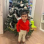 Maria-Valentina participe au concours pour gagner de l'argent avec cette photo : toddler, child, christmas_tree, red_sweater, indoor, holiday_decor, toy, teddy_bear, wooden_floor, pants, socks, face, person, home, festive, decorations, greenery, window, furniture, expression