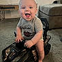 Ryder joined the competition — help win amazing prizes! baby, child, indoor, carpet, toy, smiling, happy, toddler, clothing, furniture, living_room, car, ride_on_toy, face, foot, hand, seat, wheel, head, person