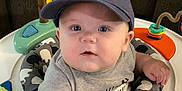 Ryder joined the competition — help win amazing prizes! baby, infant, cap, hat, alaska, activity_center, toy, colorful, blue_eyes, chubby_cheeks, toddler, indoor, couch, curious, child, person, clothing, sitting, play, cute