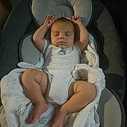 Felix joined the competition — help win amazing prizes! baby, sleeping, infant, blanket, baby_seat, cushion, arms_up, peaceful, indoors, soft_lighting, clothing, onesie, foot, leg, head, face, rest, comfort, young_child, nap