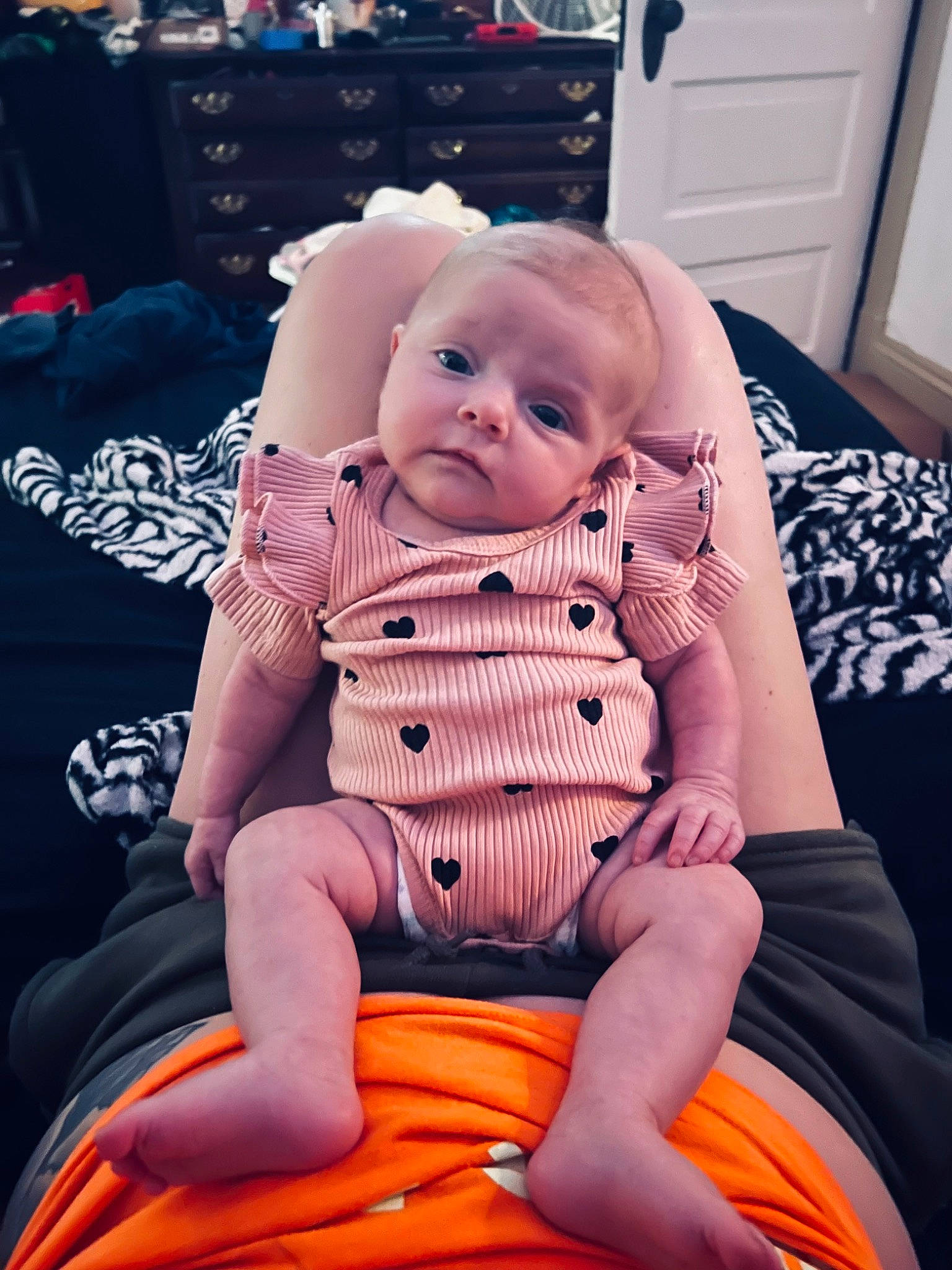 Gracelynn is registered to the contest to win money with this photo: abdomen, baby, baby_toddler_clothing, carmine, cheek, child, comfort, door, flesh, foot, happy, human_body, human_leg, knee, lap, person, room, sitting, sock, thigh