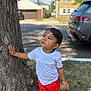 Ethan joined the competition — help win amazing prizes! toddler, child, tree, white_tshirt, red_shorts, red_shoes, outdoor, street, car, grass, sidewalk, summer, daylight, curious, person, casual_clothing, portrait, young_child, urban, nature