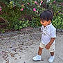 Ethan is registered to the contest to win money with this photo: toddler, child, boy, outdoor, flowers, plants, concrete, walking, white_shoes, shorts, embroidered_shirt, greenery, brick_wall, nature, daylight, side_view, curious, petals, casual_clothing, young_child
