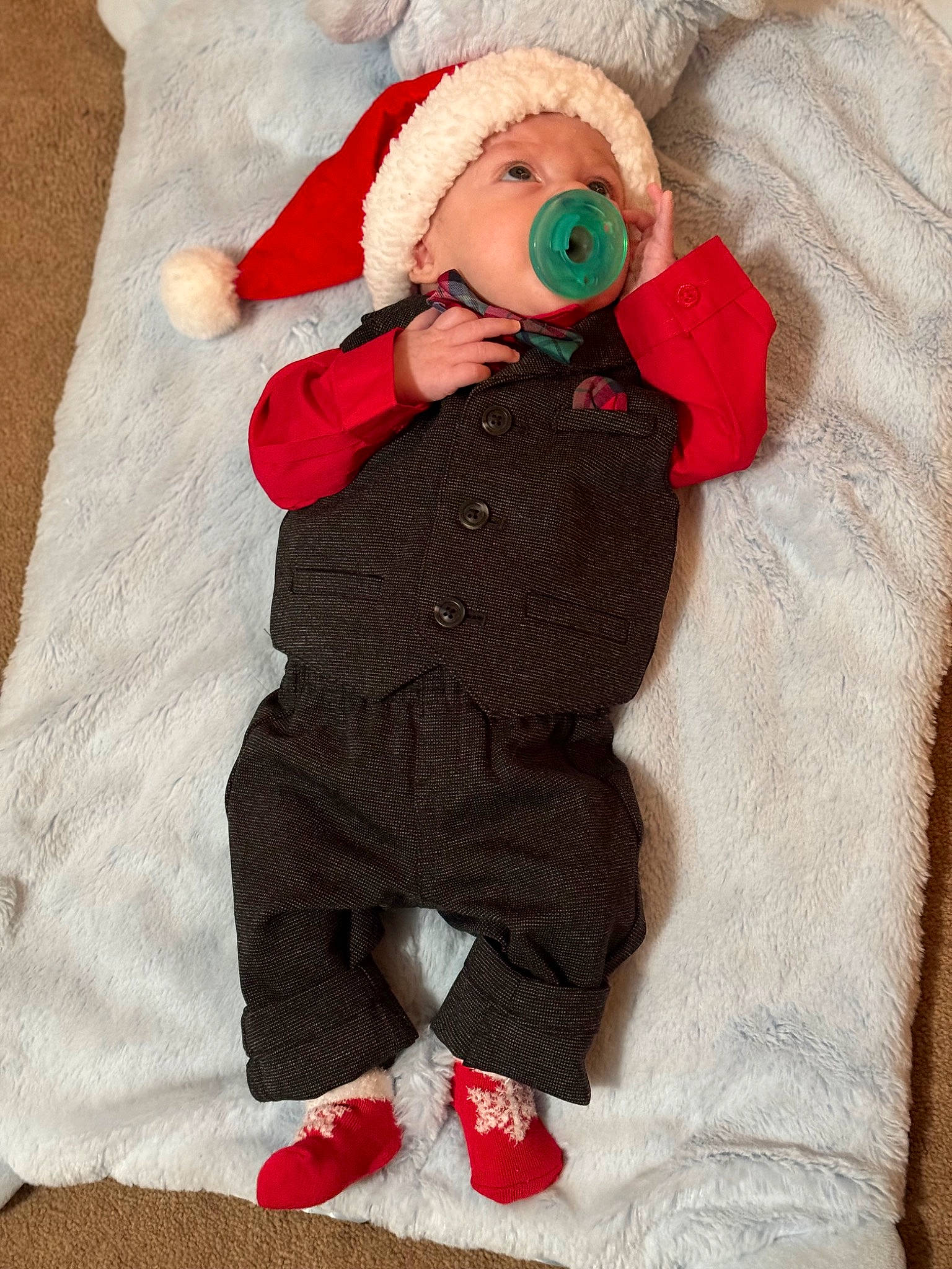 Carlyle is registered to the contest to win money with this photo: baby, baby_sleeping, baby_toddler_clothing, cap, child, comfort, fictional_character, fur, hat, headwear, knit_cap, linens, pattern, person, red, santa_claus, sleeve, stuffed_toy, textile, toddler