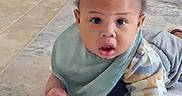 Kingston joined the competition — help win amazing prizes! baby, child, infant, play_mat, bib, camo_shirt, curly_hair, indoor, floor, expression, looking, hands, colorful, soft, cozy, person, young, cute, portrait, toddler