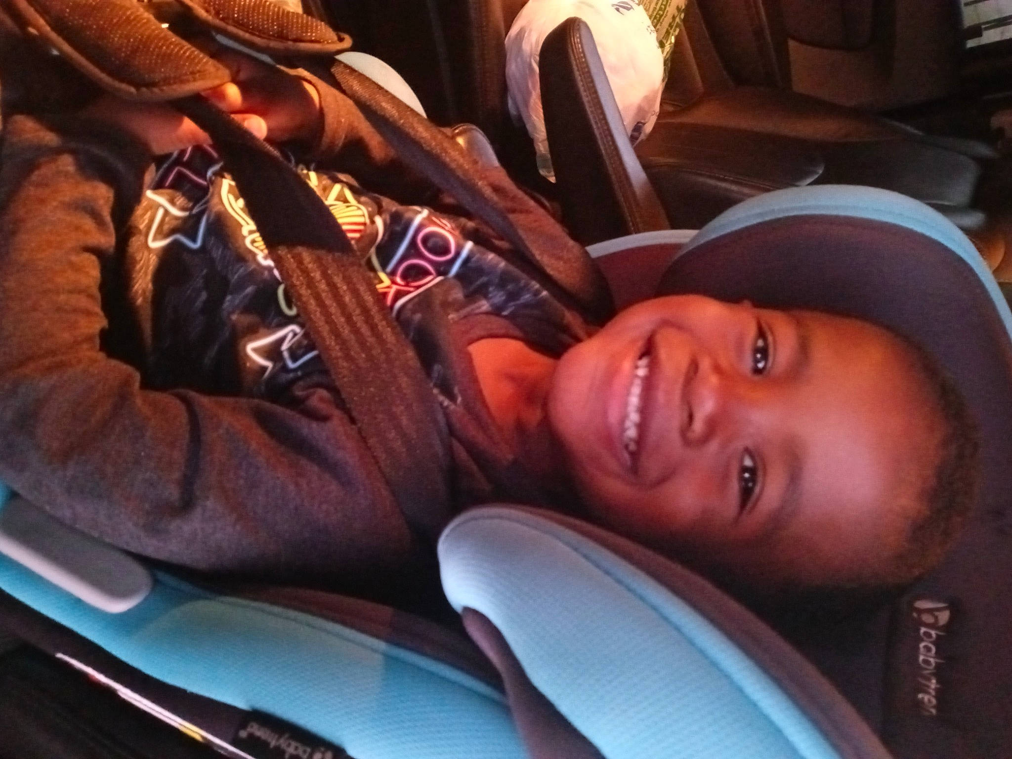 Patrick is registered to the contest to win money with this photo: automotive_design, automotive_exterior, car_seat, comfort, cool, event, family_car, fun, happy, joy, leisure, luxury_vehicle, mammal, motor_vehicle, mouth, person, sitting, smile, steering_wheel, t_shirt