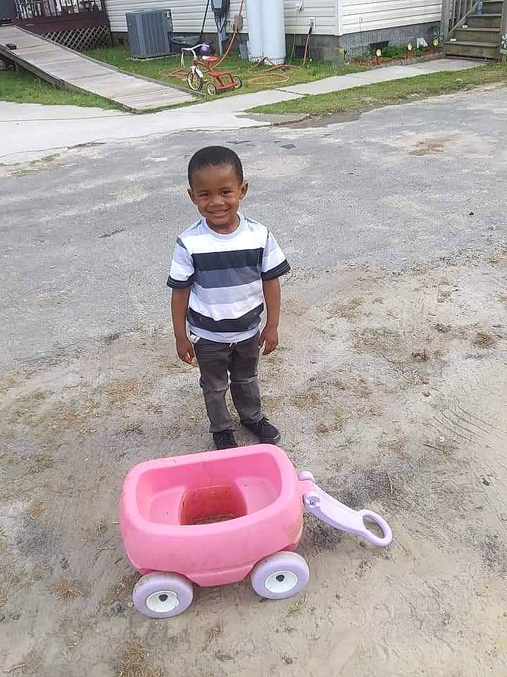Patrick joined the competition — help win amazing prizes! asphalt, automotive_tire, bucket, child, concrete, door, fun, joy, leisure, outdoor_play_equipment, person, plant, plastic, recreation, road_surface, shorts, sitting, soil, tire, toddler