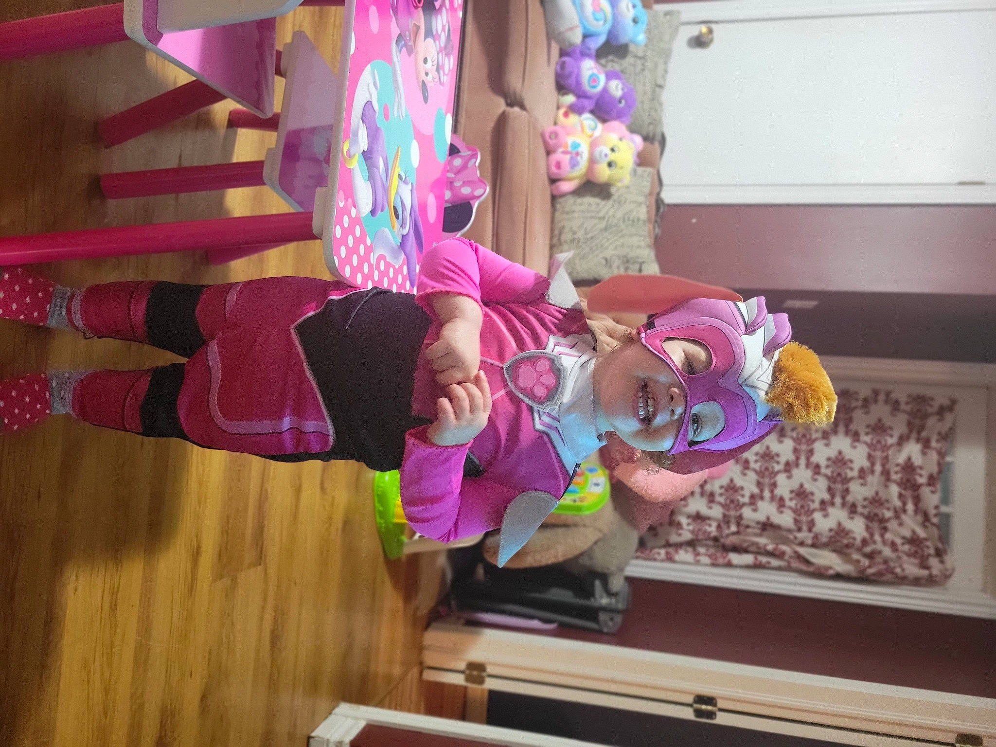 Esme is registered to the contest to win money with this photo: animation, child, costume, entertainment, event, fun, hardwood, hat, leisure, magenta, person, pink, plant, purple, room, thigh, toy, tree, wood