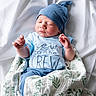 Charles joined the competition — help win amazing prizes! newborn, baby, infant, blue_hat, blue_clothing, blanket, swaddled, sleeping, peaceful, white_background, soft_texture, cute, portrait, child, resting, indoor, fabric, smiling, tiny_hands, cozy
