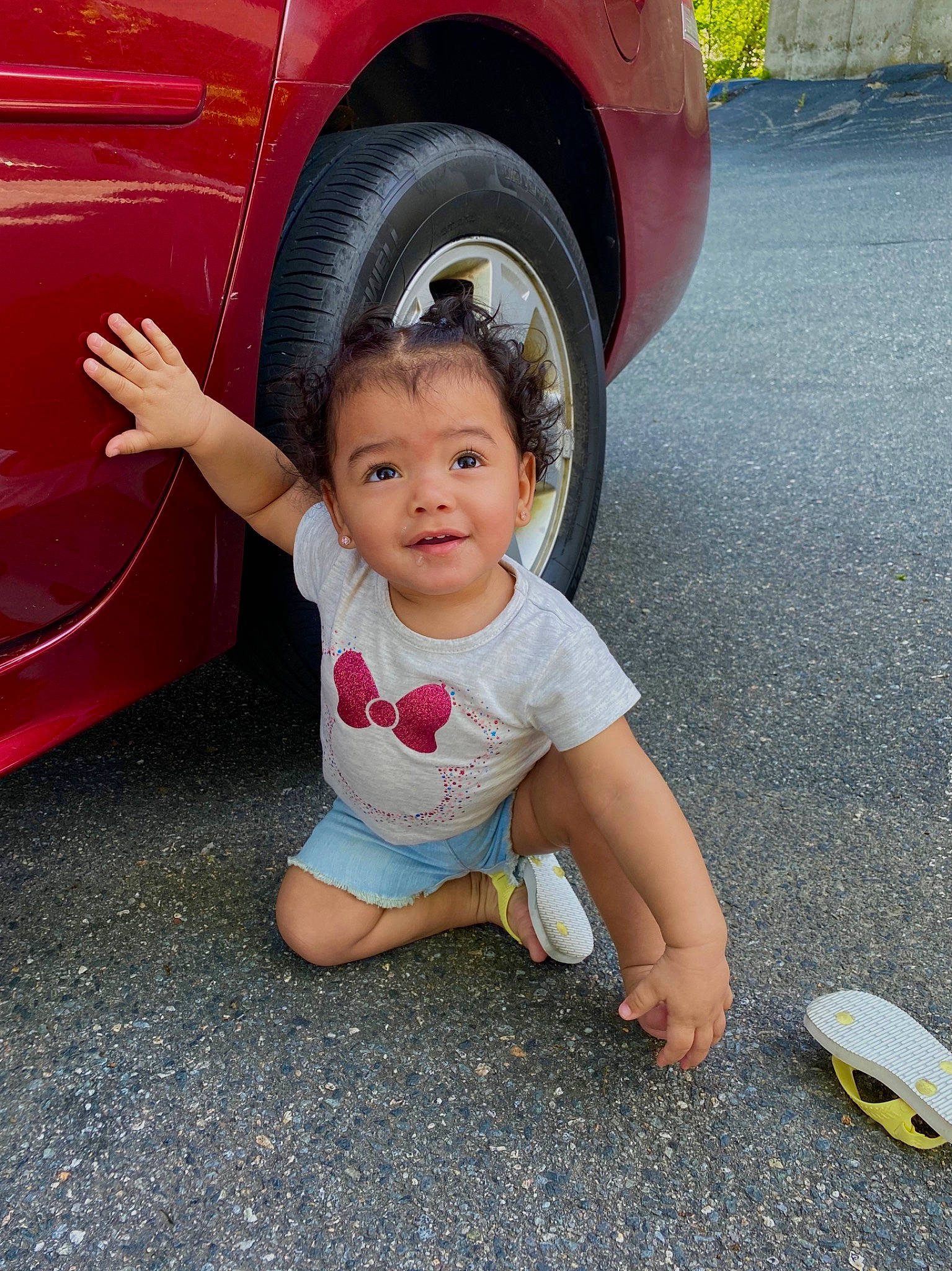 Melissa is registered to the contest to win money with this photo: baby, car, child, hand, joy, person, play, red, skin, smile, toddler, vacation, vehicle, vehicle_door, yellow