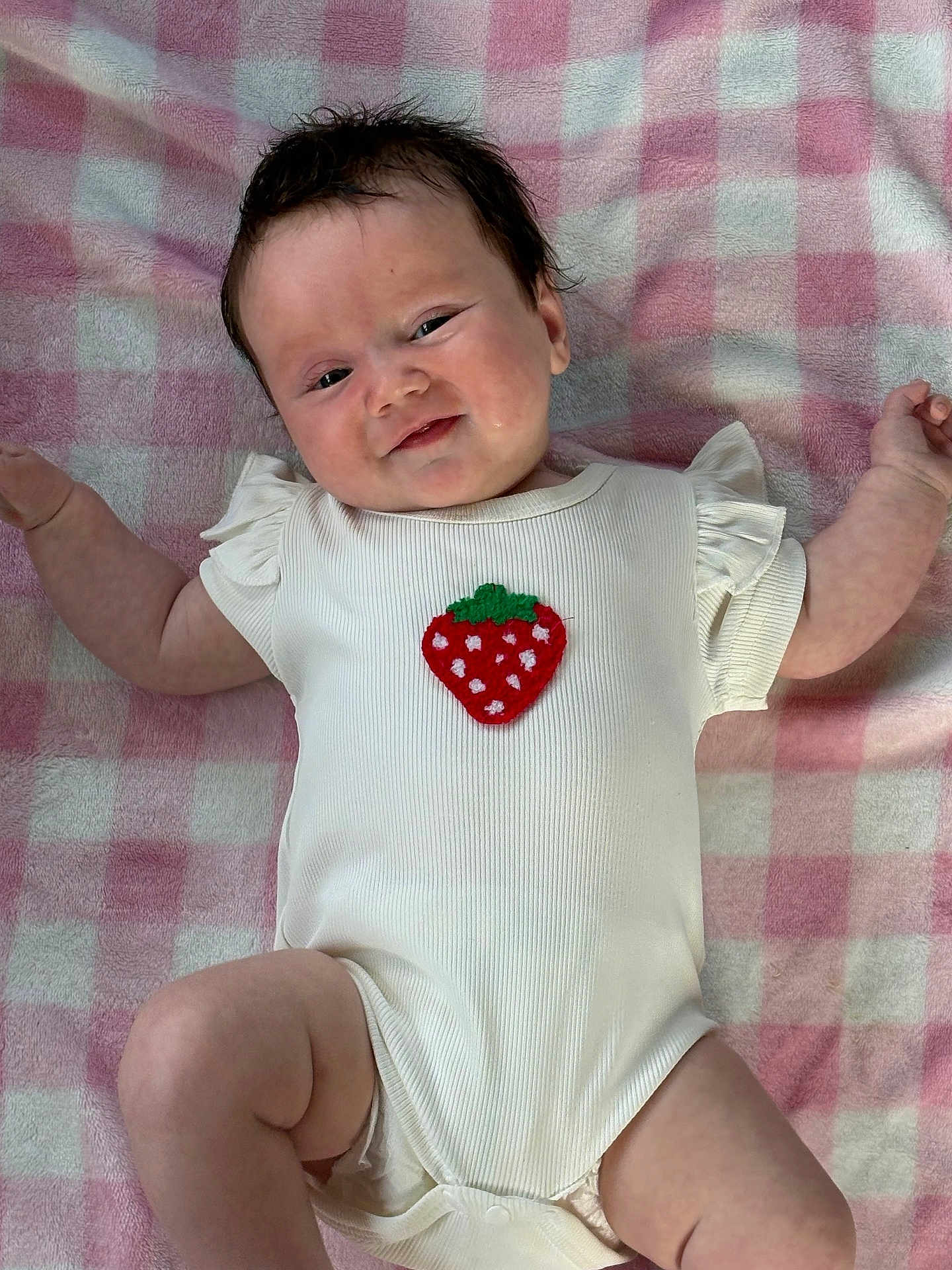 Sophie joined the competition — help win amazing prizes! baby, infant, onesie, strawberry_patch, blanket, pink, white, smile, arms, legs, cute, child, face, skin, hair, lying_down, clothing, happy, soft, indoors
