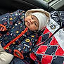 Adonys participe au concours pour gagner de l'argent avec cette photo : baby, child, jacket, hat, patterned_clothing, car_interior, person, warm_clothes, colorful, seated, portrait, infant, cute, cozy, bundle, seat, winter_wear, baby_face, adult, closeup