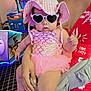 baby, child, sunglasses, hat, pink, dress, tutu, hand, adult, arcade, gaming_machine, floor, pattern, person, indoor, fashion, accessory, red_dress, holding, cute
