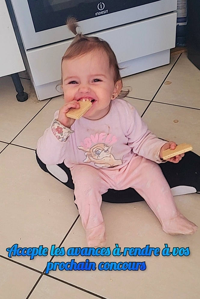 Talya participe au concours pour gagner de l'argent avec cette photo : baby, baby_toddler_clothing, cheek, child, finger, floor, flooring, happy, hardwood, home_appliance, joint, mouth, person, pink, product, sitting, skin, sleeve, t_shirt, thumb