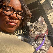 Leo Thompson joined the competition — help win amazing prizes! person, cat, kitten, glasses, bow_tie, leash, outdoor, sunlight, portrait, face, hair, building, door, number, animal, pet, feline, closeup, expression, home