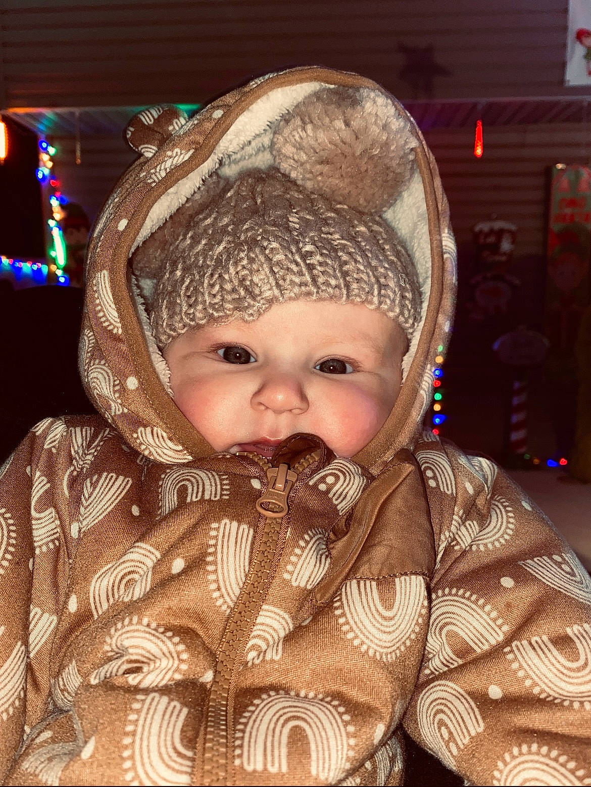 Juniper is registered to the contest to win money with this photo: baby, baby_toddler_clothing, beanie, beard, cap, cheek, child, christmas, event, eye, fun, happy, headwear, human_body, jacket, knit_cap, person, sitting, skin, smile