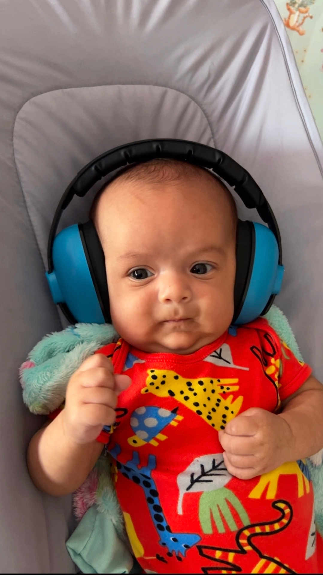 Hari joined the competition — help win amazing prizes! baby, headphones, colorful_clothing, animal_print, infant, fist, blanket, cushion, face, portrait, child, cute, indoor, expression, soft, comfort, newborn, person, skin, young
