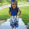 Keniyah joined the competition — help win amazing prizes! child, girl, blue_dress, bow, long_hair, smiling, standing, outdoor, grass, road, porch, steps, white_sandals, necklace, summer, sunny, nature, trees, happy, portrait