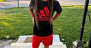 Keniyah joined the competition — help win amazing prizes! adidas, casual, child, girl, grass, house, lantern, outdoor, person, porch, red_bow, shirt, shorts, slippers, smile, socks, steps, street, sunset, trees