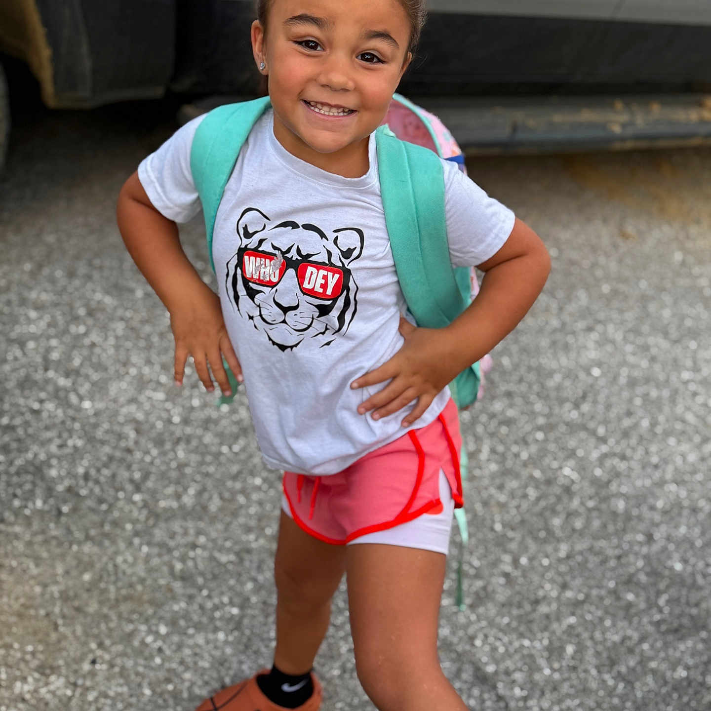 Keniyah joined the competition — help win amazing prizes! child, smiling, outdoor, tshirt, shorts, backpack, person, standing, confident_pose, gravel, vehicle, footwear, happy, casual_clothing, young, summer, cute, playful, portrait, fashion
